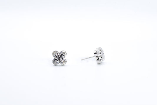 Pair of silver stud earrings on a white background