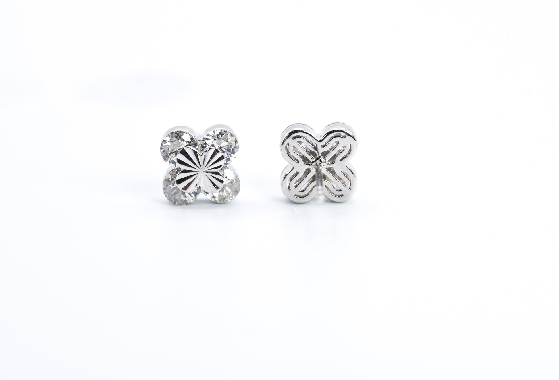 Pair of silver butterfly earrings on a white background