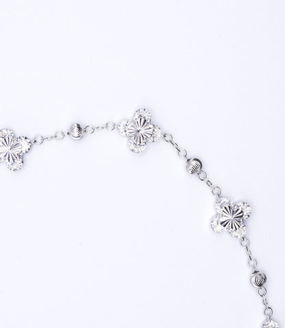 Silver bracelet with floral designs on a white background
