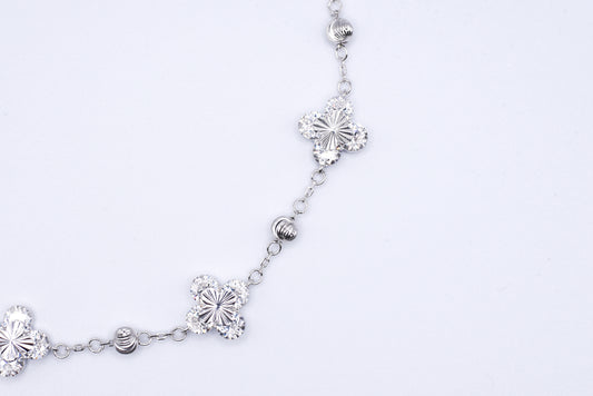Silver bracelet with floral designs on a white background