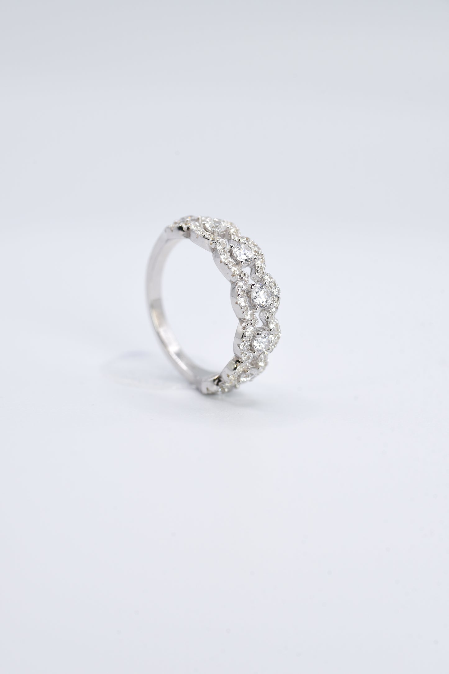 silver ring with multiple stones on a white background