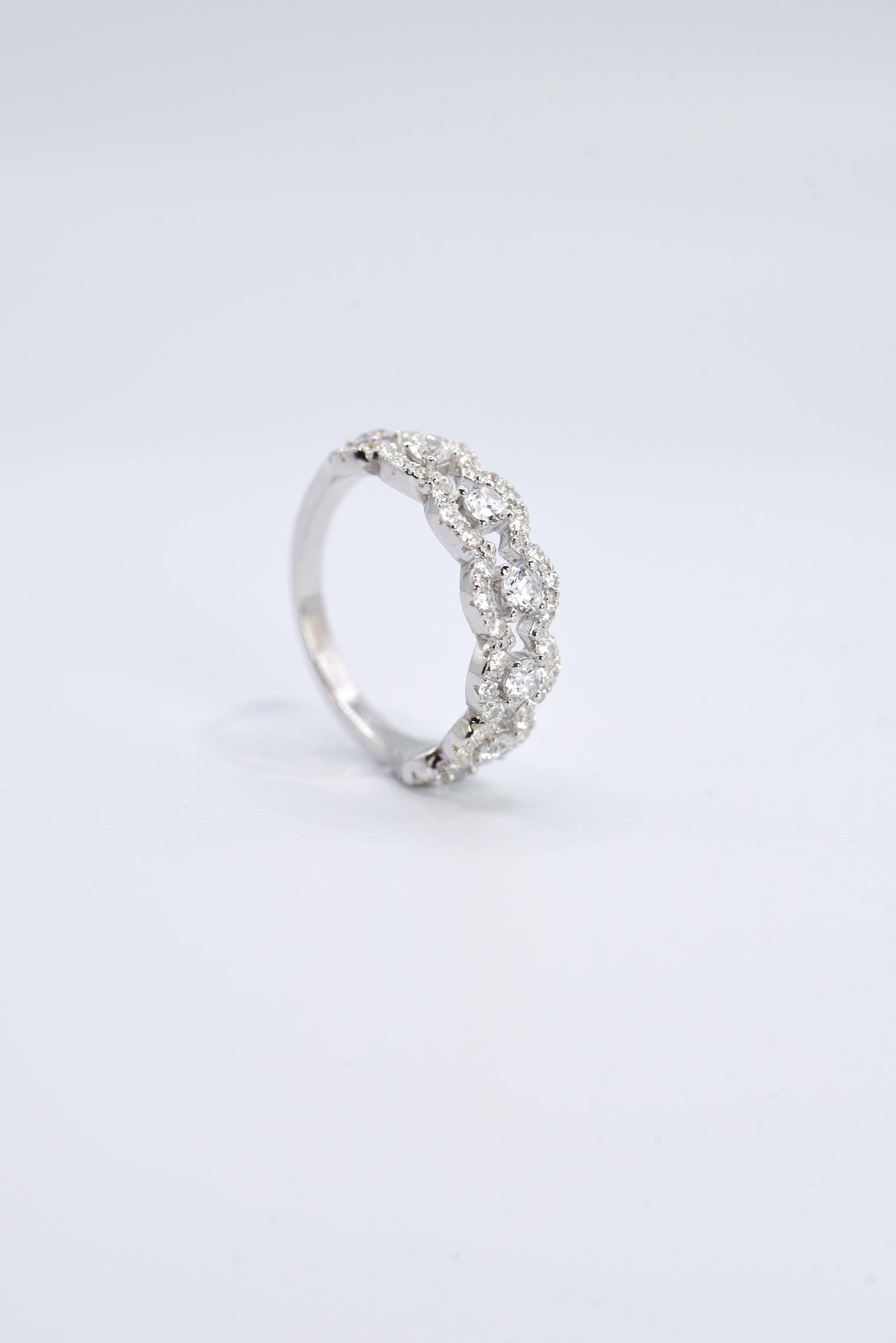 silver ring with multiple stones on a white background
