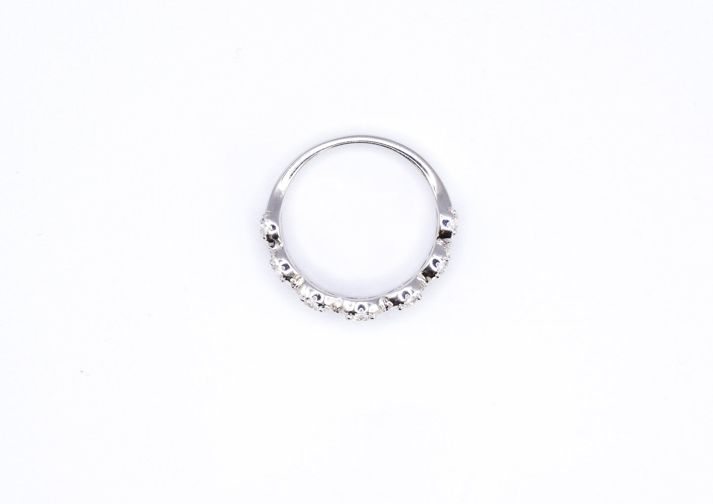 silver ring with multiple stones on a white background