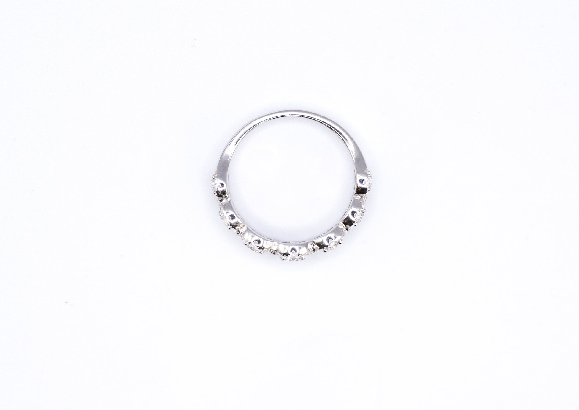 silver ring with multiple stones on a white background