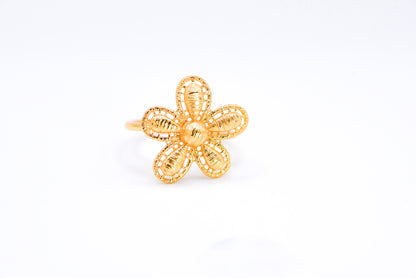 Gold flower-shaped ring on a white background