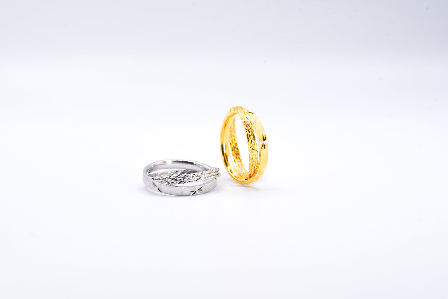 Gold and silver rings on a light gray background