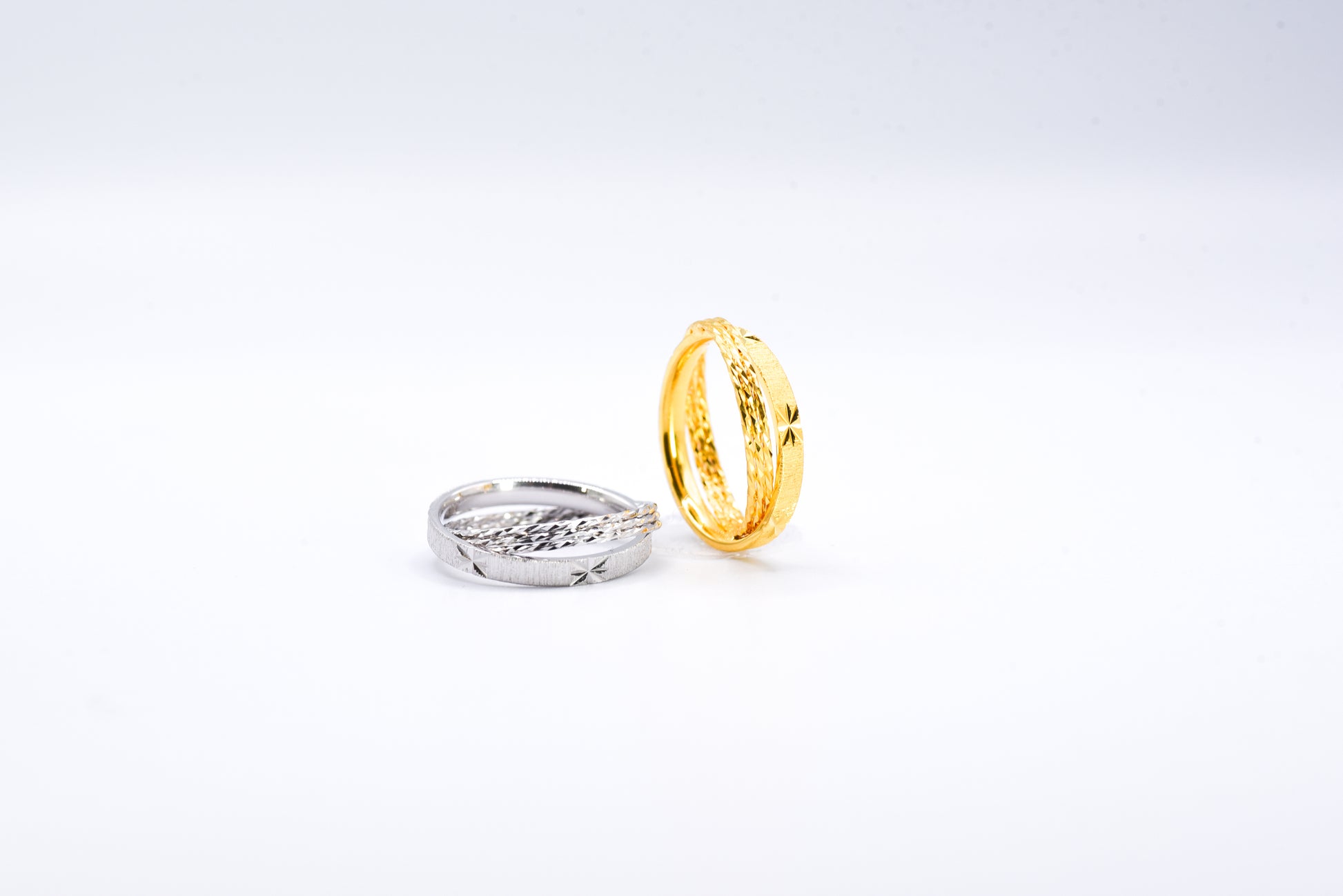 Gold and silver rings on a light gray background