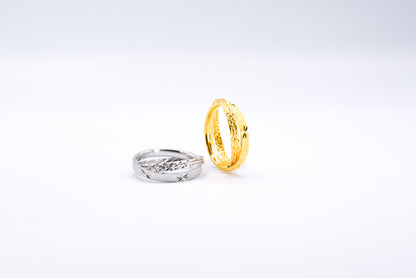 Gold and silver rings on a light gray background