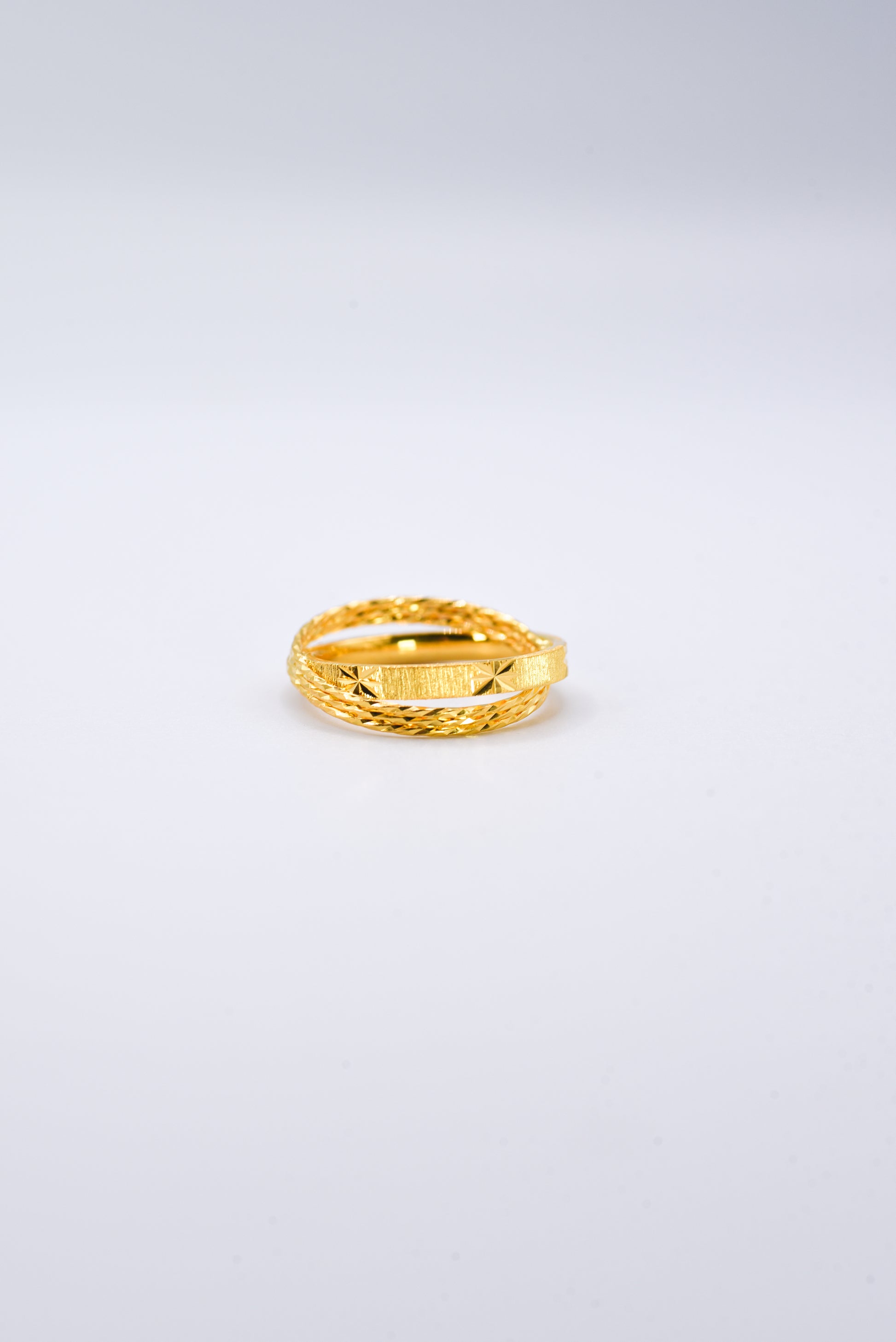 Gold ring on a light gray background
