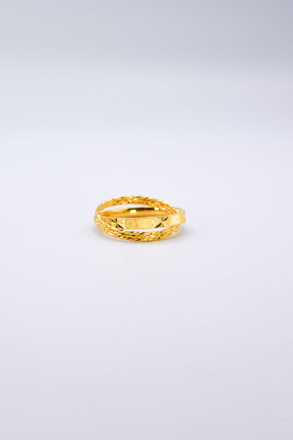 Gold ring on a light gray background