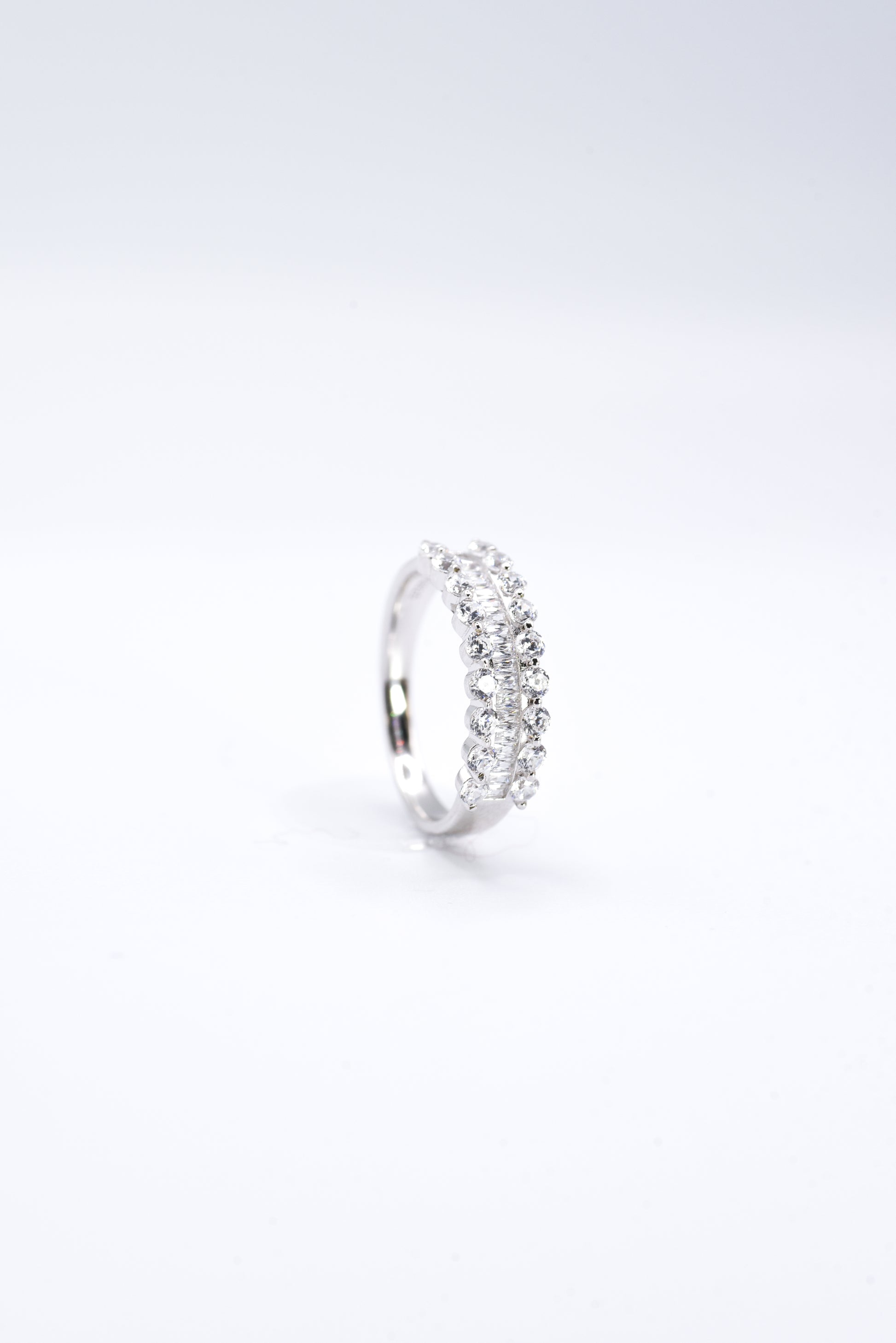 Silver ring with multiple gemstones on a white background