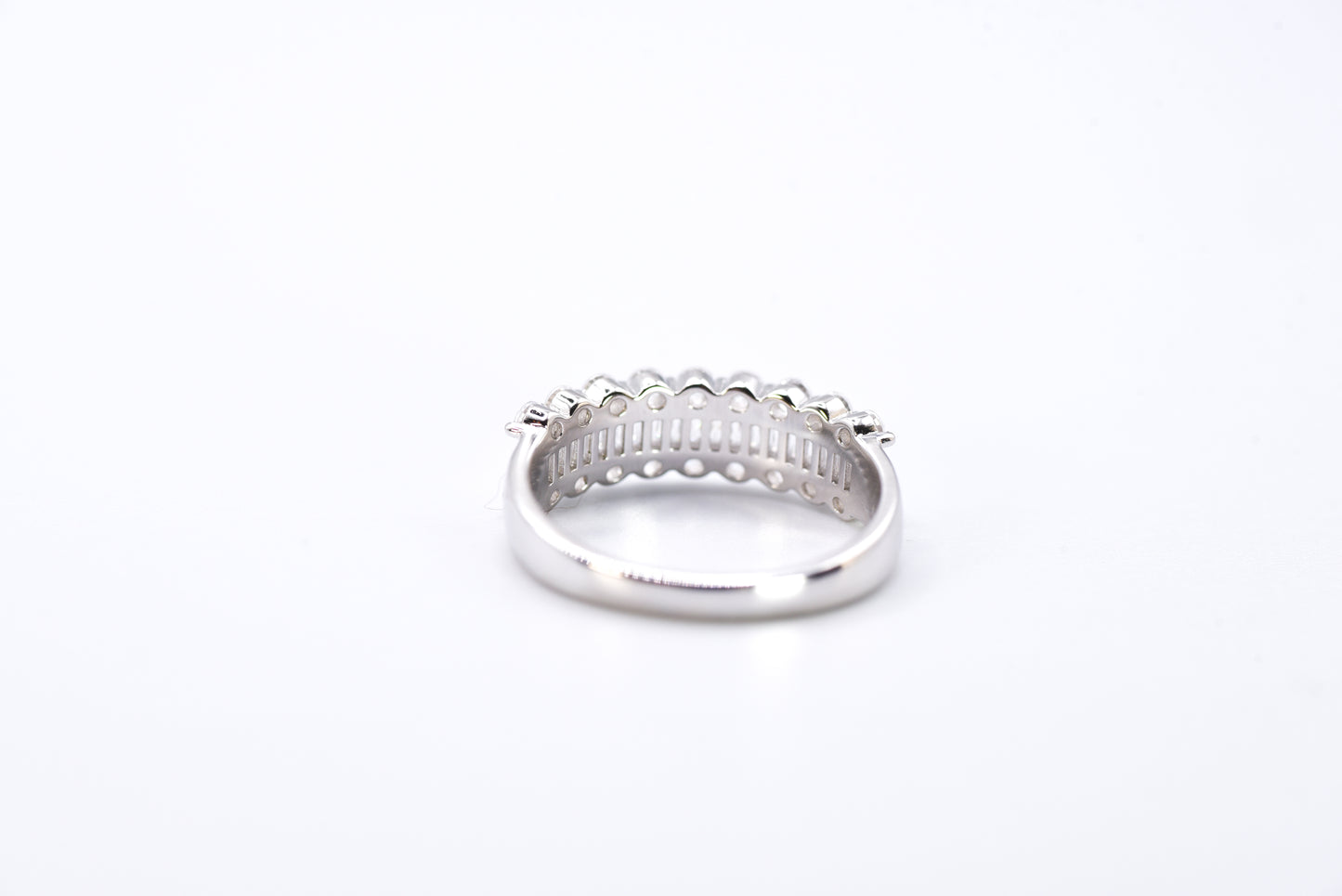 Silver ring with multiple gemstones on a white background