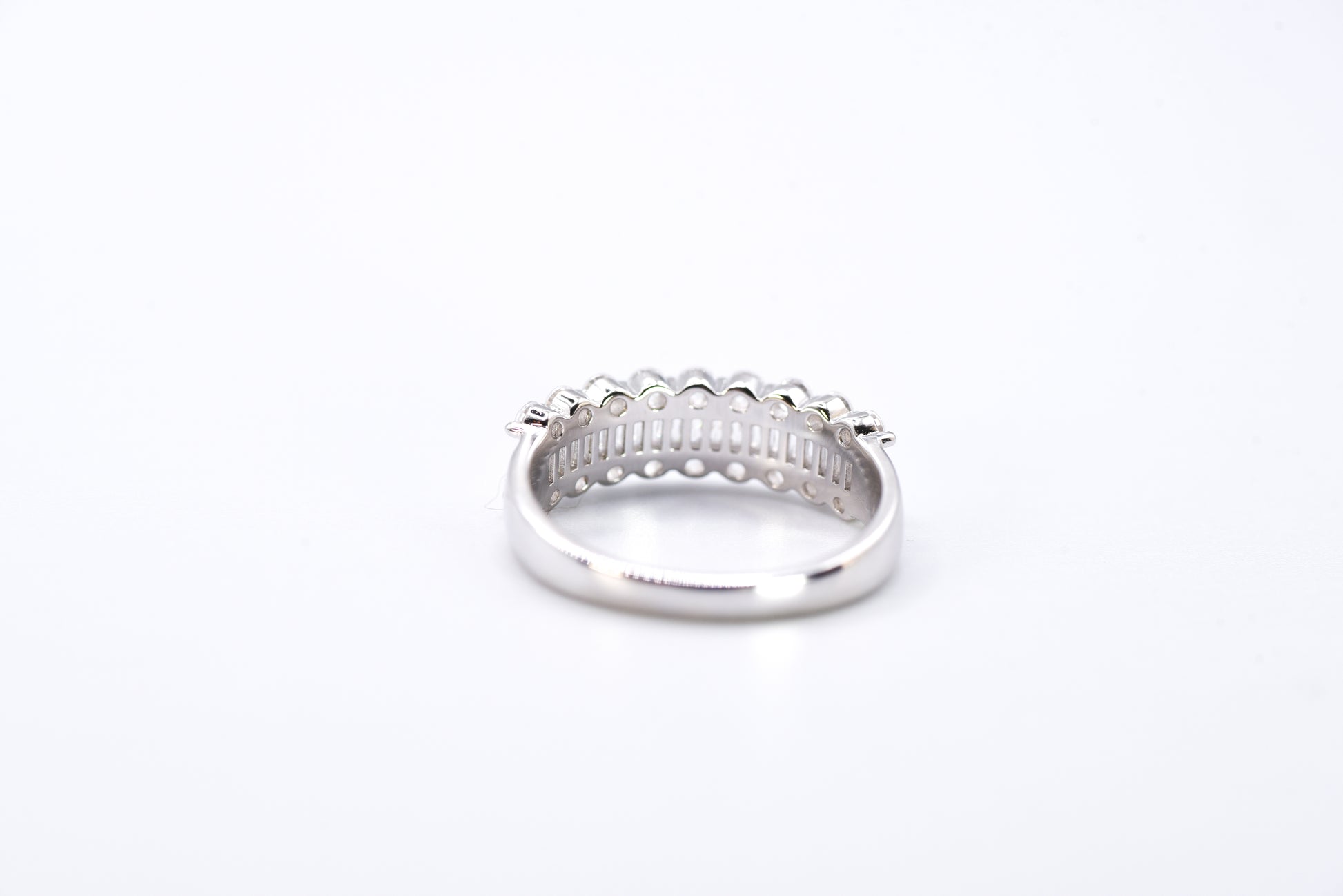 Silver ring with multiple gemstones on a white background