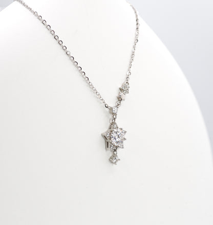 Silver necklace with a star-shaped pendant on a white background