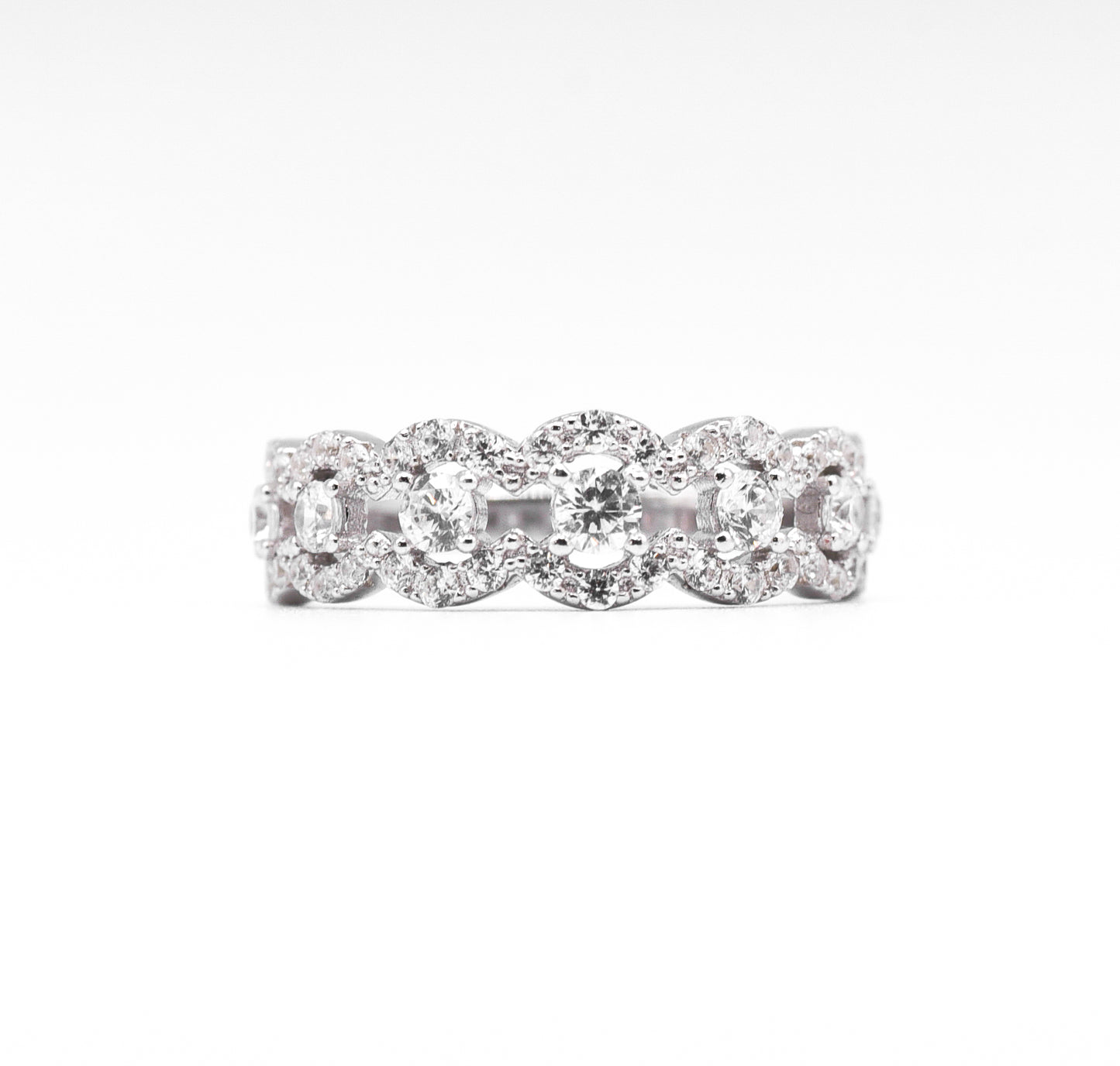 silver ring with multiple stones on a white background