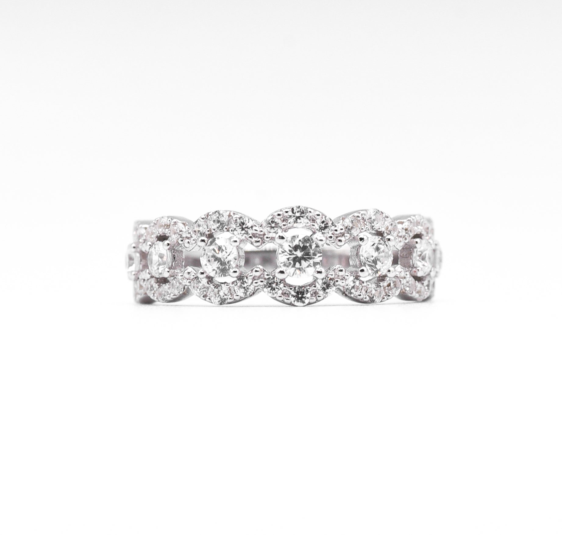 silver ring with multiple stones on a white background