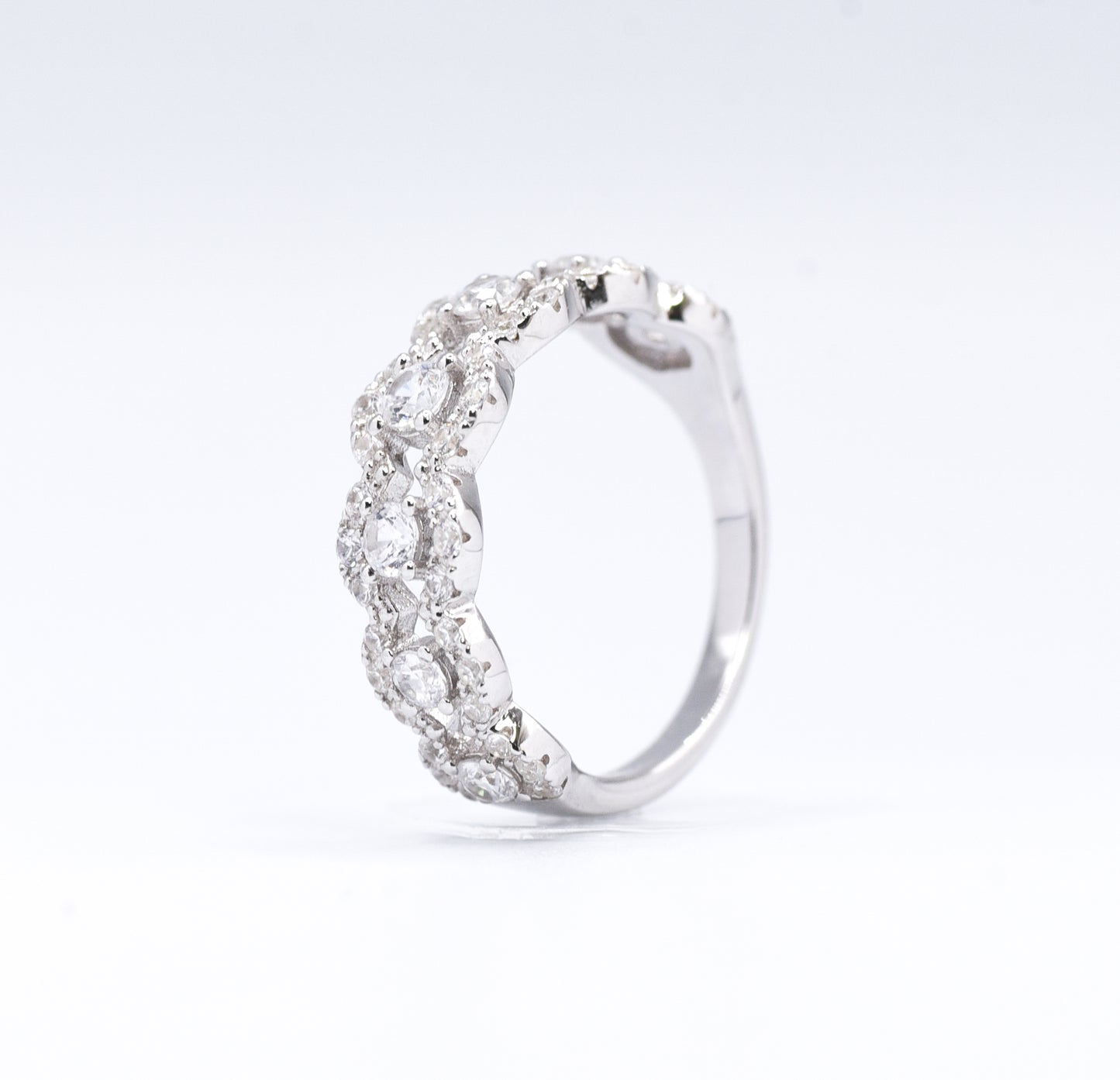 silver ring with multiple stones on a white background