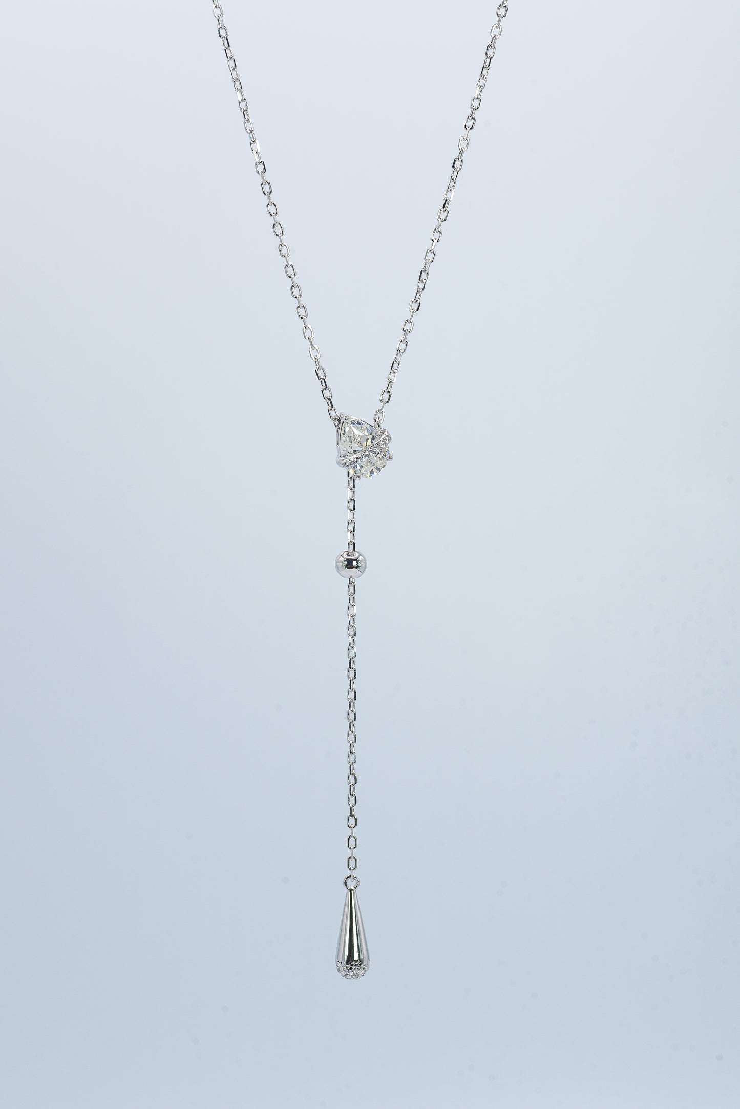 Lunelle Atelier Dew Drop Lariat Necklace featuring delicate chain and teardrop pendant on a neutral background.