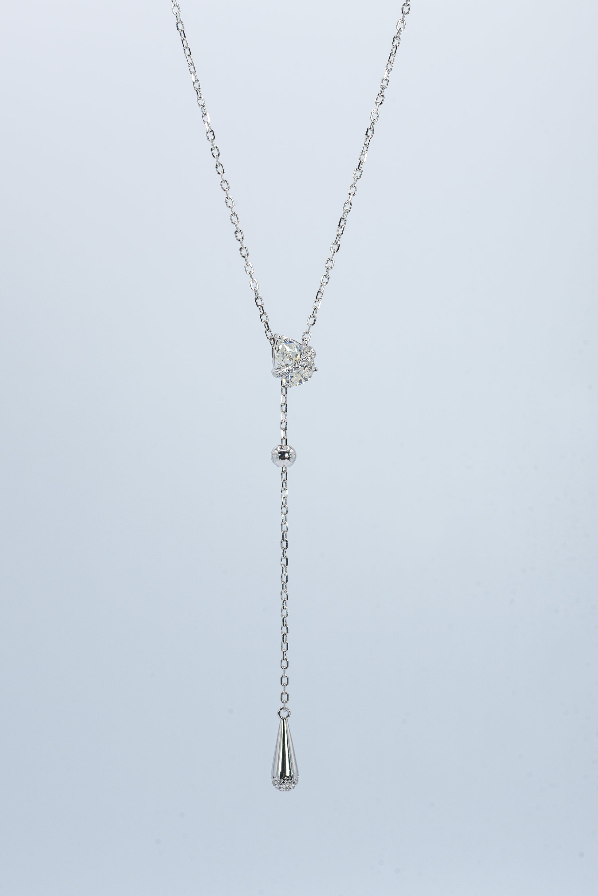 Lunelle Atelier Dew Drop Lariat Necklace featuring delicate chain and teardrop pendant on a neutral background.