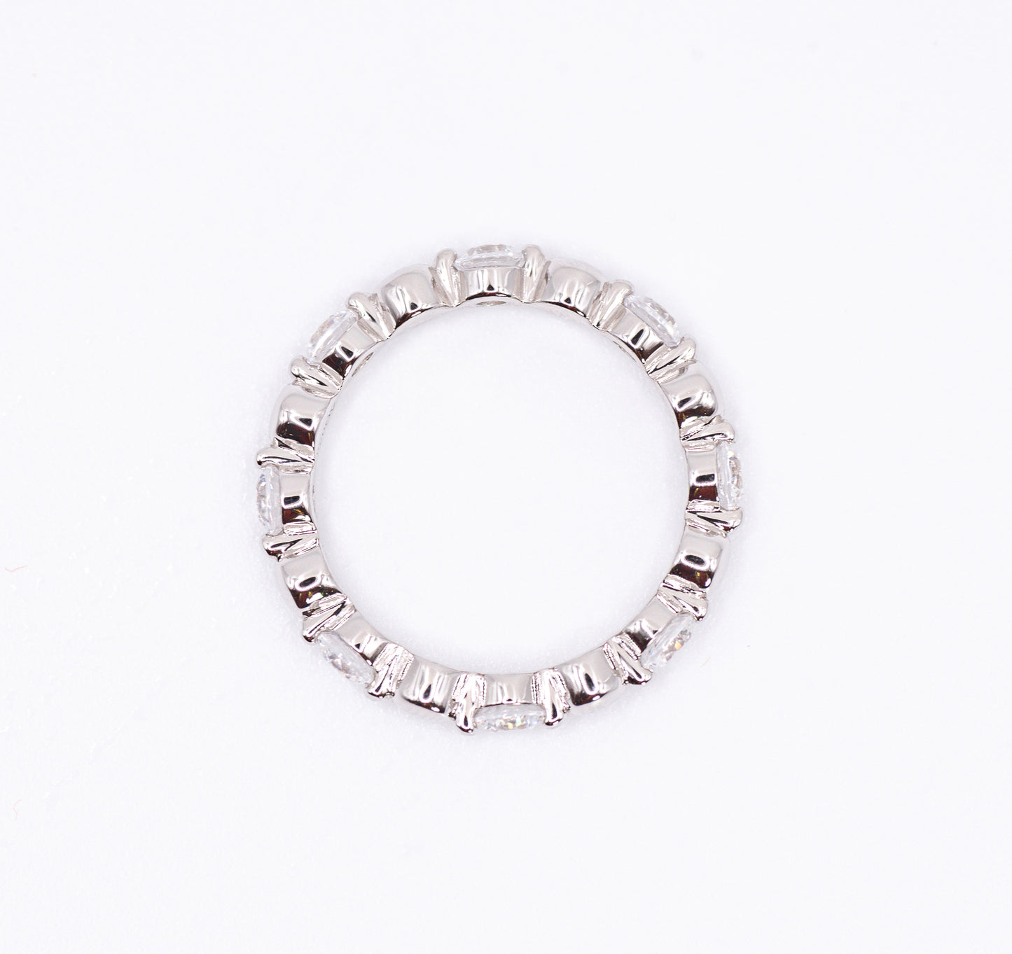 Silver ring with baguette cut gemstones on a white background
