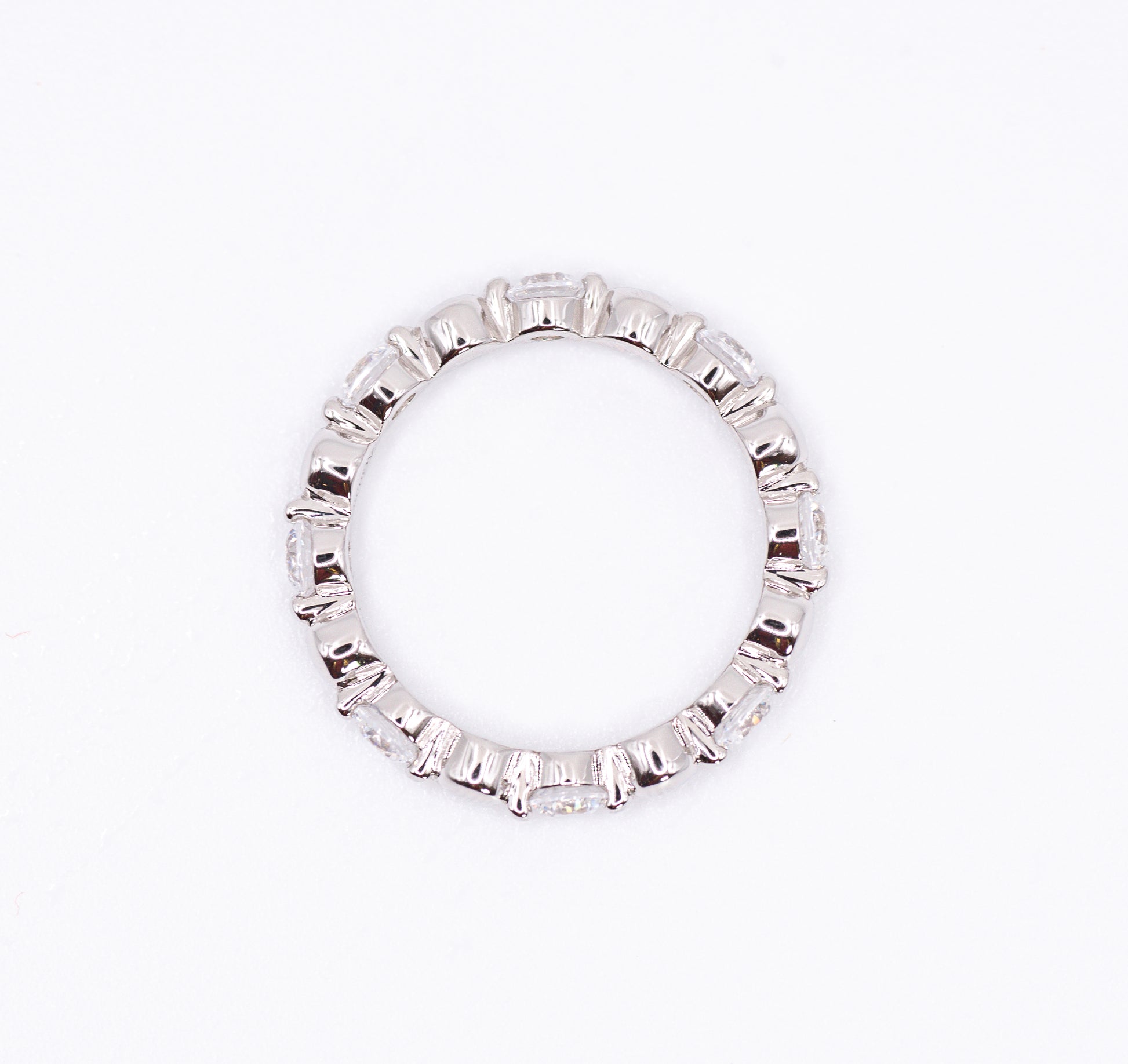 Silver ring with baguette cut gemstones on a white background