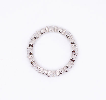 Silver ring with baguette cut gemstones on a white background