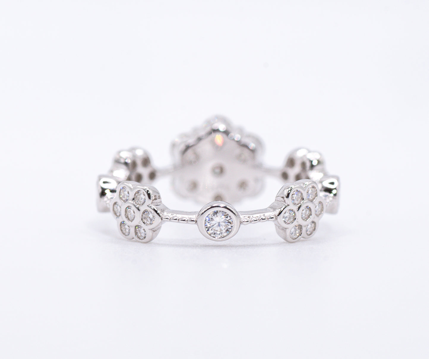 back of Silver earring with paw print design on a white background