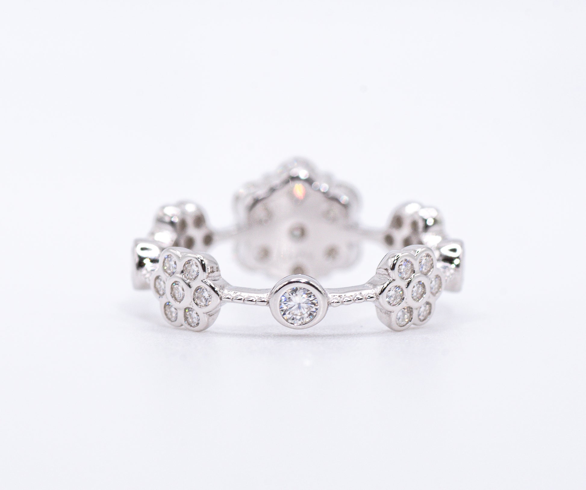 back of Silver earring with paw print design on a white background