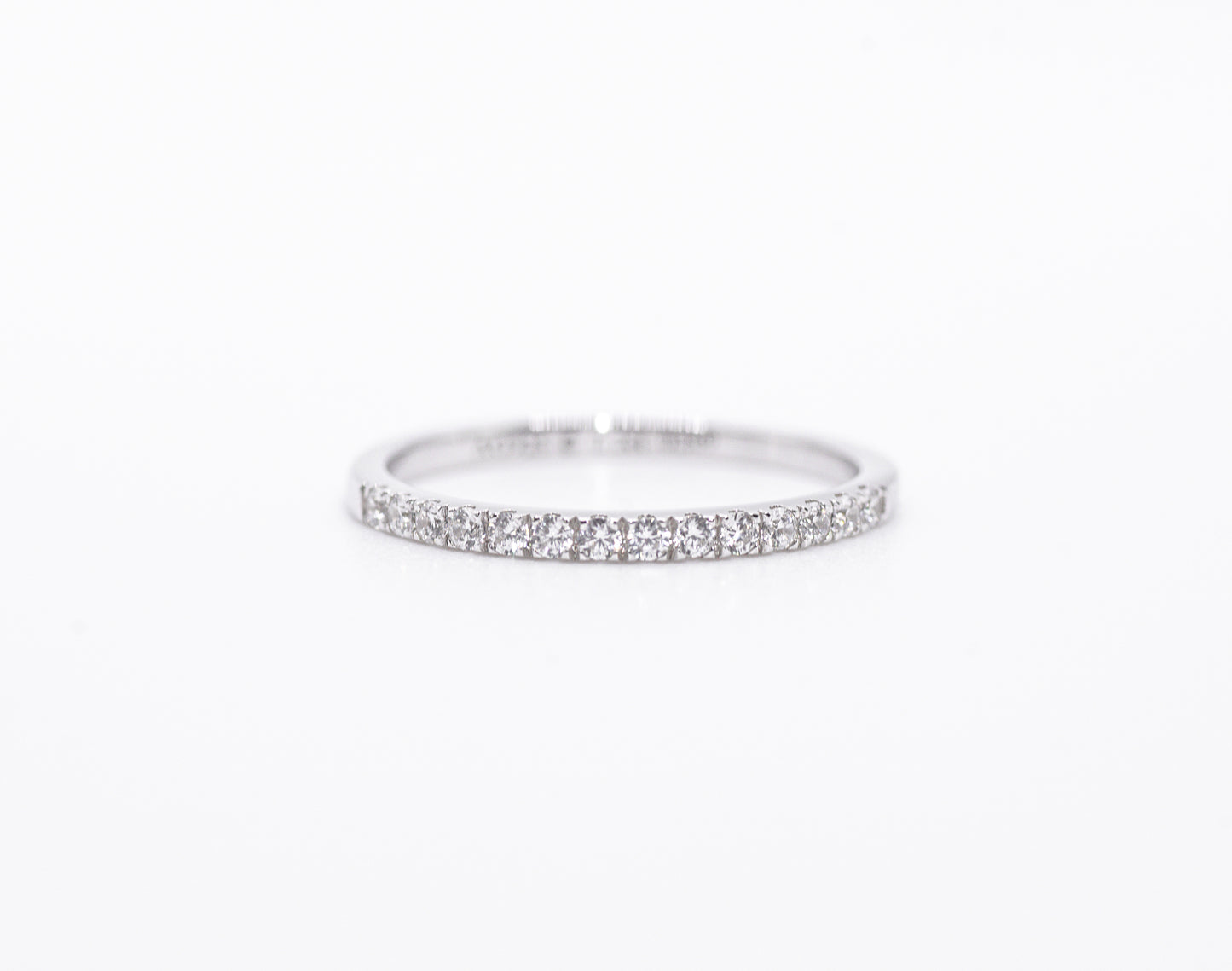 Silver ring with small stones on a white background