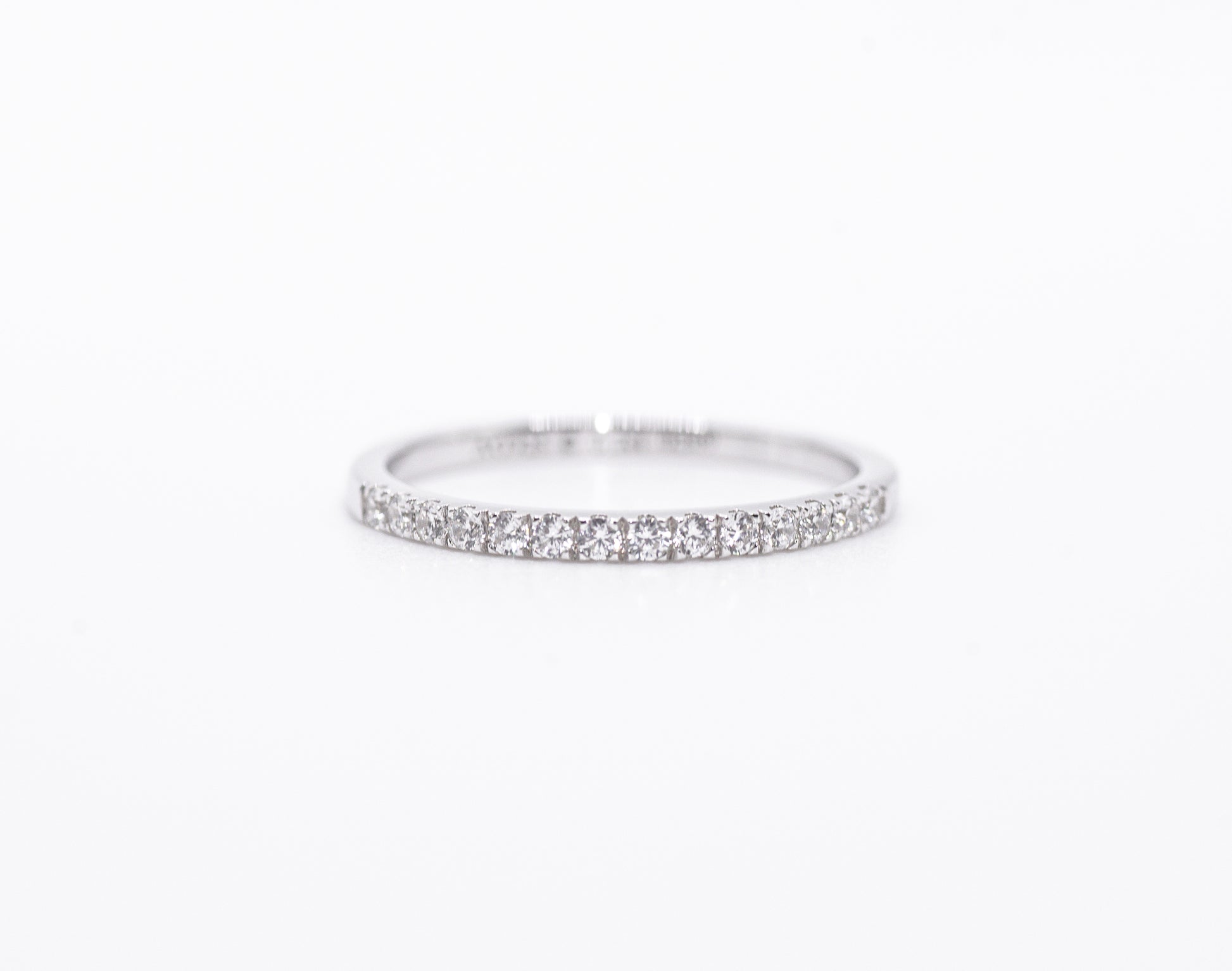 Silver ring with small stones on a white background
