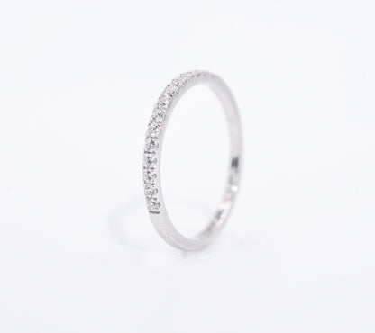 Silver ring with small gemstones on a light gray background