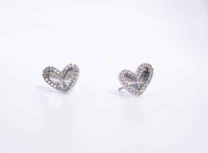 Heart-shaped earrings with clear gemstones on a white background