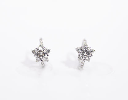 Star-shaped earrings with clear stones on a white background