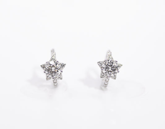 Star-shaped earrings with clear stones on a white background