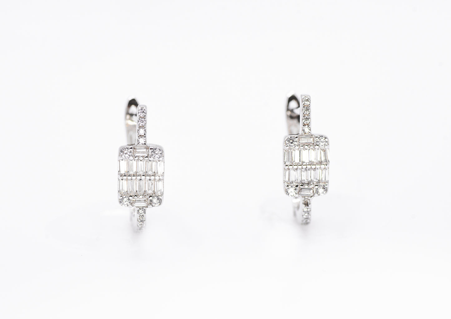 Pair of diamond earrings on a white background