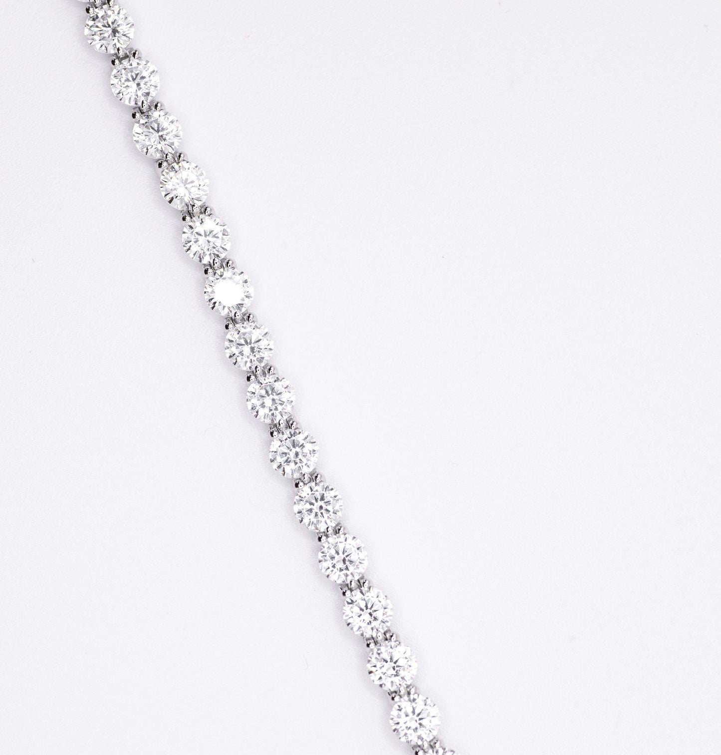 Silver bracelet with multiple gemstones on a white background