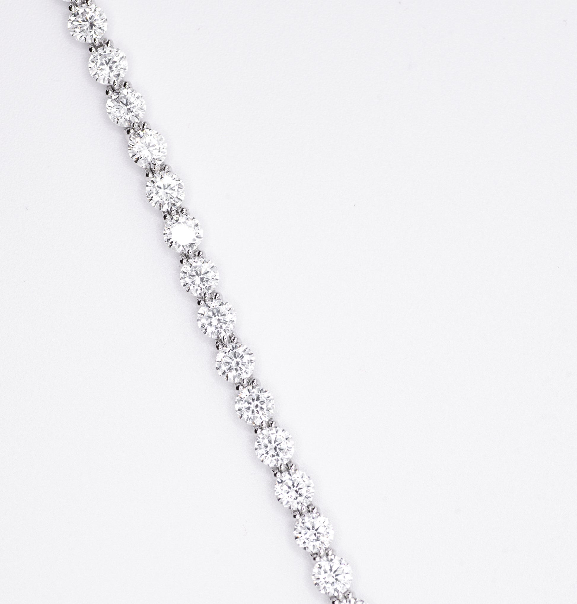 Silver bracelet with multiple gemstones on a white background