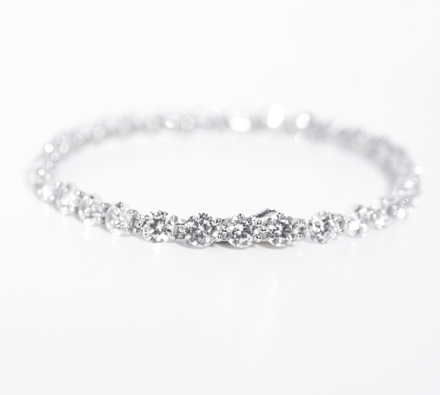 Silver bracelet with multiple gemstones on a white background