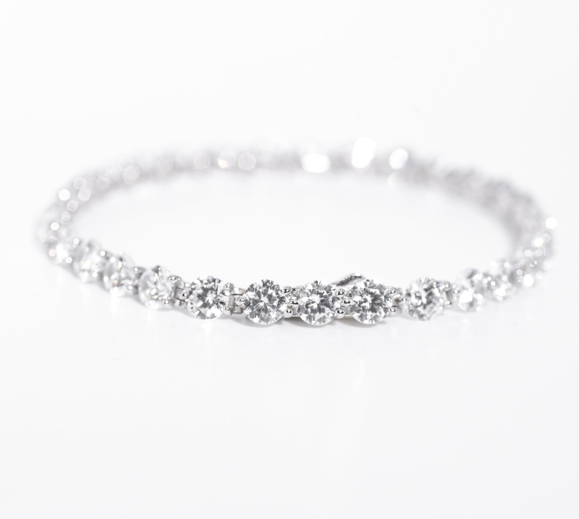 Silver bracelet with multiple gemstones on a white background