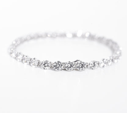 Silver bracelet with multiple gemstones on a white background