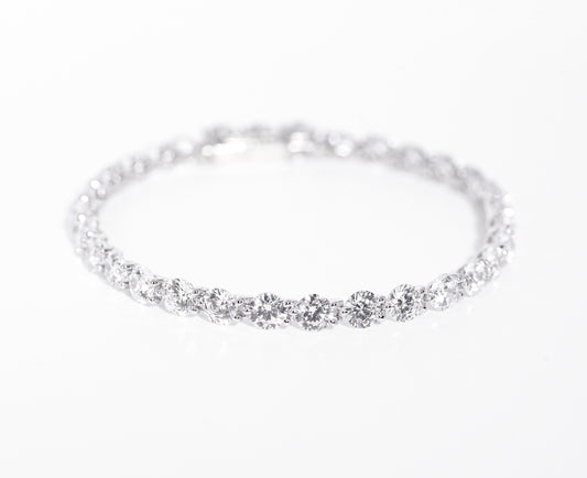 Silver bracelet with multiple gemstones on a white background