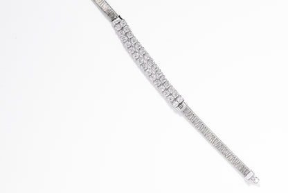 Silver bracelet with clear gemstones on a white background