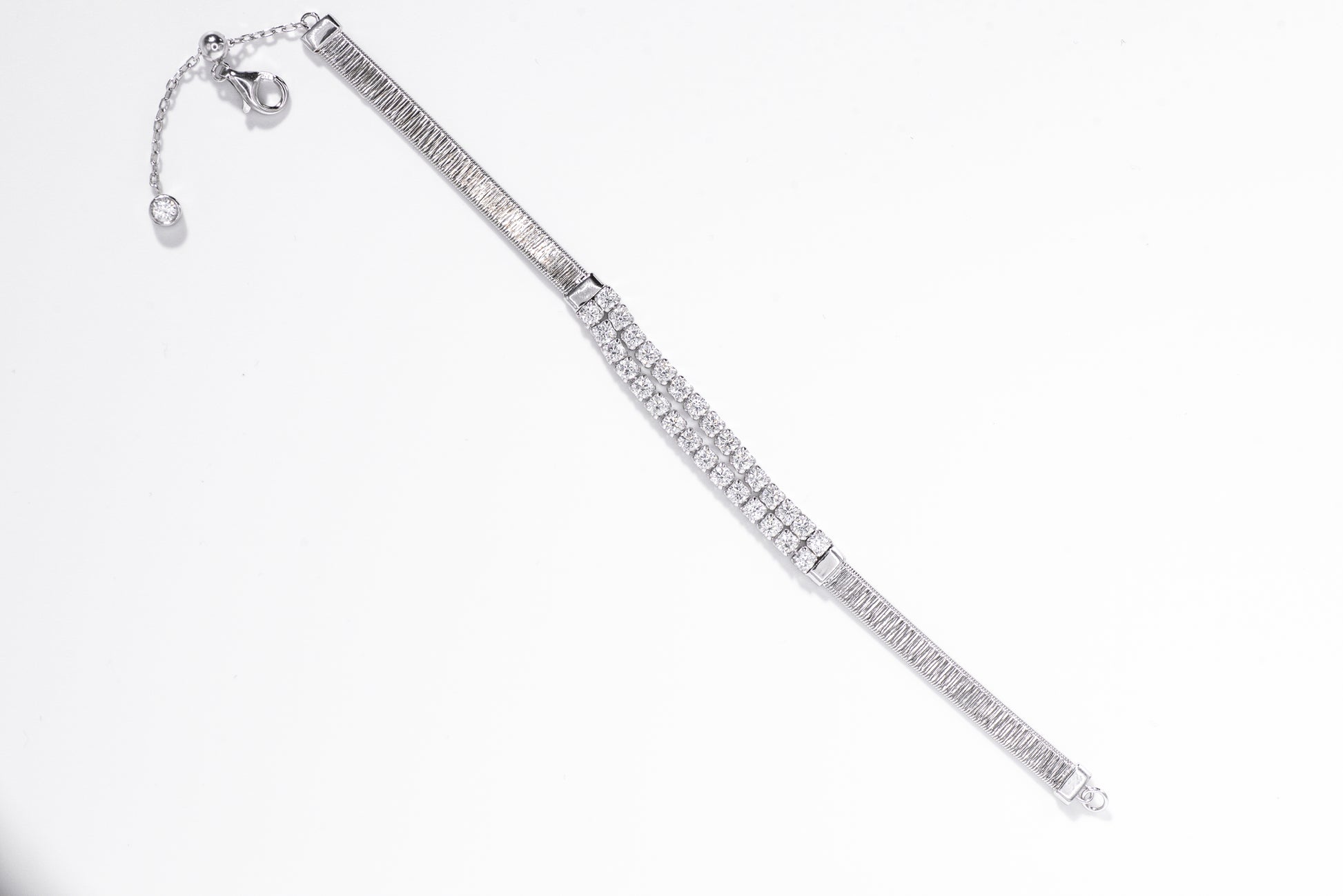 Silver bracelet with clear gemstones on a white background