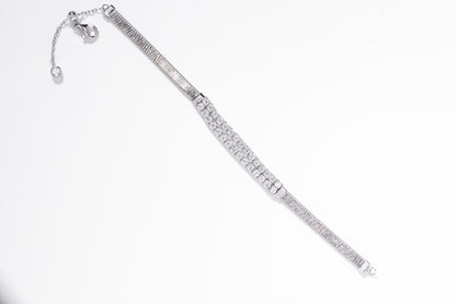 Silver bracelet with clear gemstones on a white background