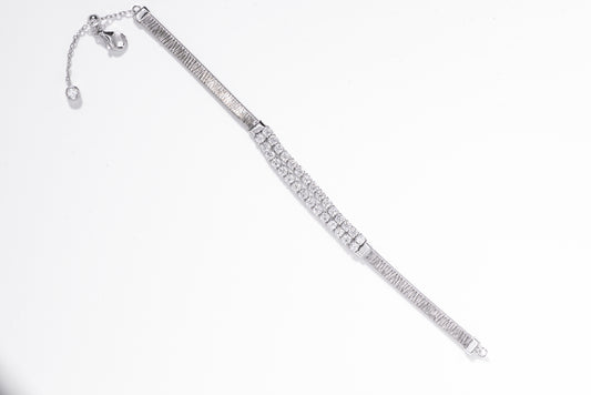 Silver bracelet with clear gemstones on a white background