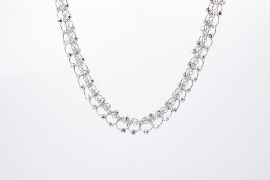 Silver necklace with light gray background