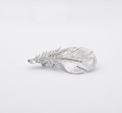 Silver feather-shaped pendant on a light gray background
