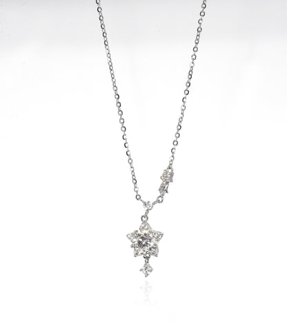 Silver necklace with a star-shaped pendant on a white background