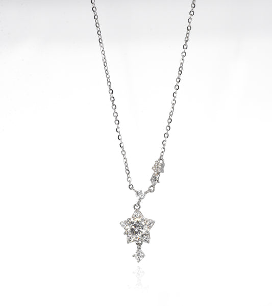 Silver necklace with a star-shaped pendant on a white background