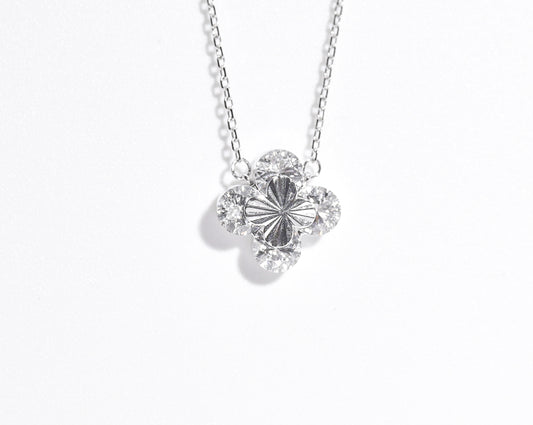 Silver necklace with a floral pendant on a white background